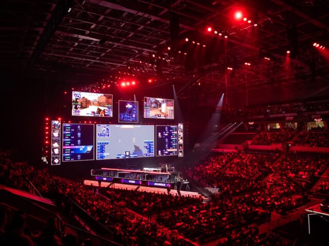 MOSCOW, RUSSIA - 14th SEPTEMBER 2019: esports Counter-Strike: Global Offensive event. Big illuminated main stage of a computer games tournament located on a big stadium. Tribunes are full of video